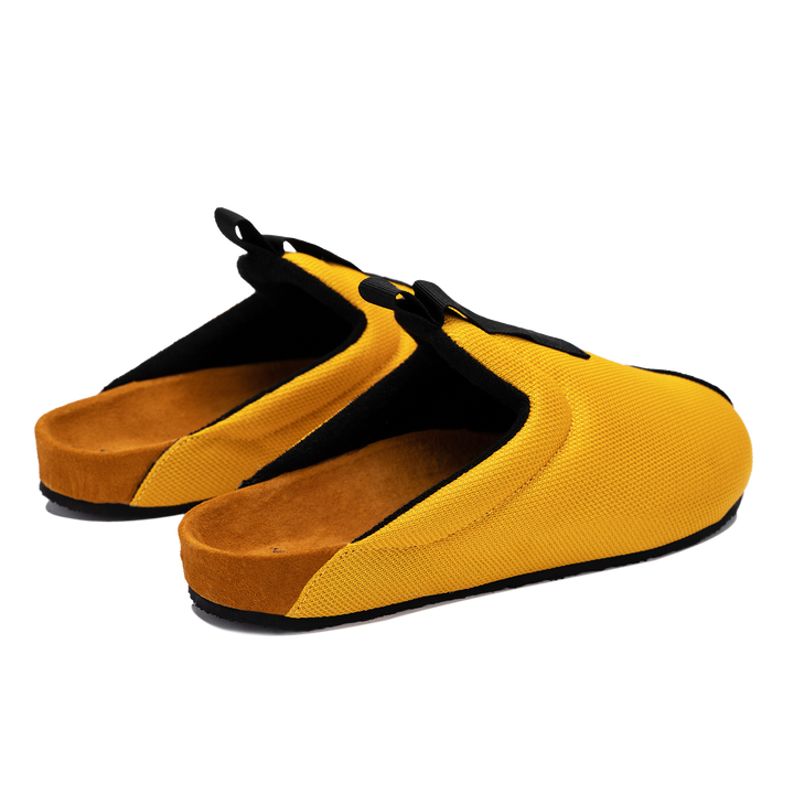 Back 3/4 view Bantha 2.0 Yellow is a Mule made of Yellow mesh with a Black hairy suede to overlay, cork midsole with suede top lining Black VIbram rubber bottom and woven top pull