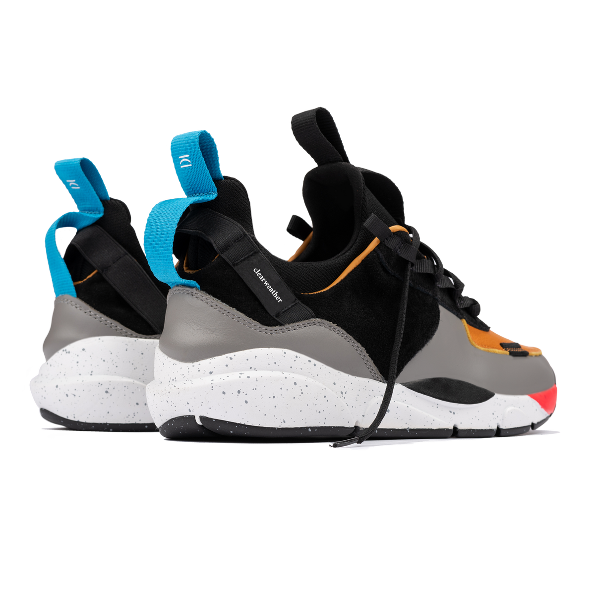 Back 3/4 view, The Contera Kalahari is a Runner with grey leather black suede and tabaco orange leather, Blue webbing heel pull, Black webbin tongue pull, Black webbing lace system, painted eva midsole ande black rubber outsole.